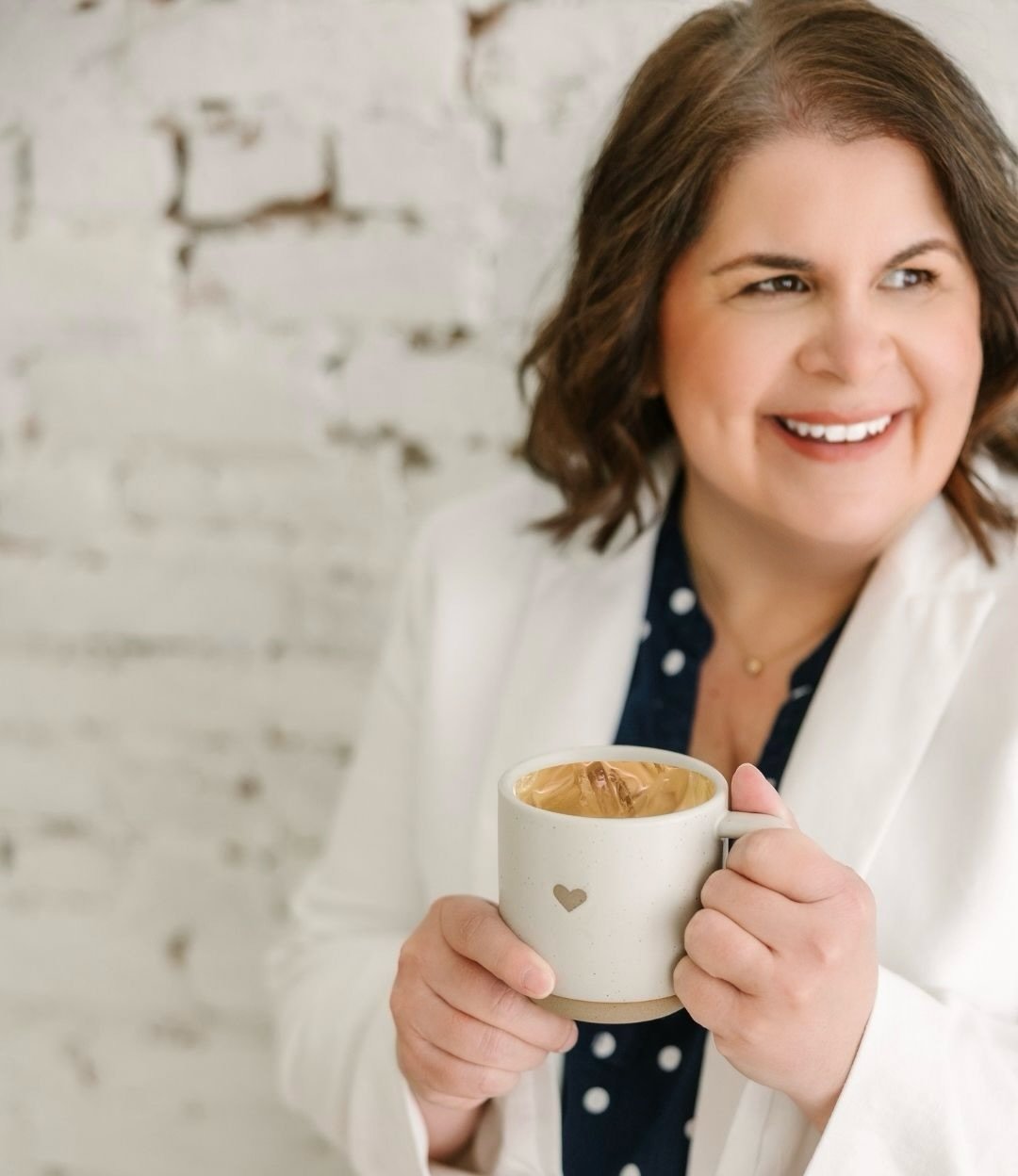 Kim Sprought holding a coffee mug